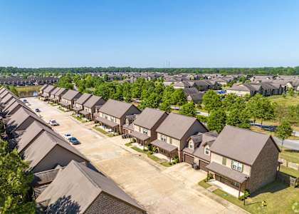 an aerial view of a neighborhood with rows of houses
