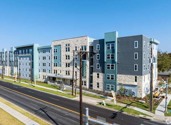 A street view of a row of modern apartment buildings.