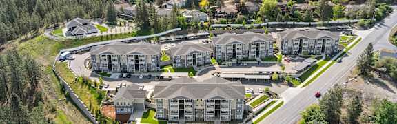 A bird's eye view of a residential area with houses and a river.
