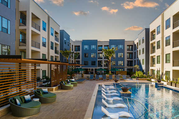 a rendering of an apartment building with a pool in the foreground