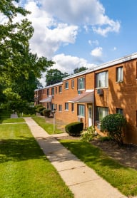 a row of brick apartment buildings on a sidewalk