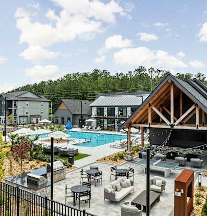 A large outdoor gathering area with a pool and a pavilion.
