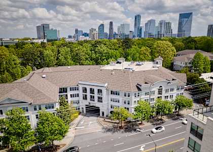 A view of a city from a high vantage point with a building in the foreground.