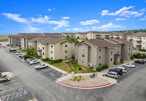 A parking lot in front of apartment buildings.