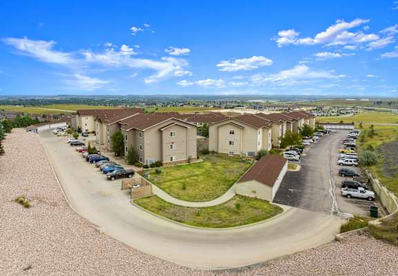 A residential area with houses and cars parked in the driveways.