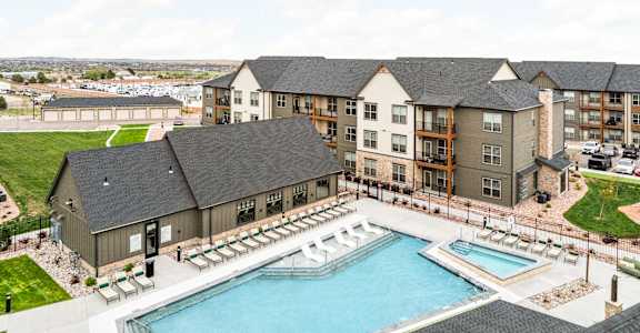 an aerial view of an apartment building with a swimming pool