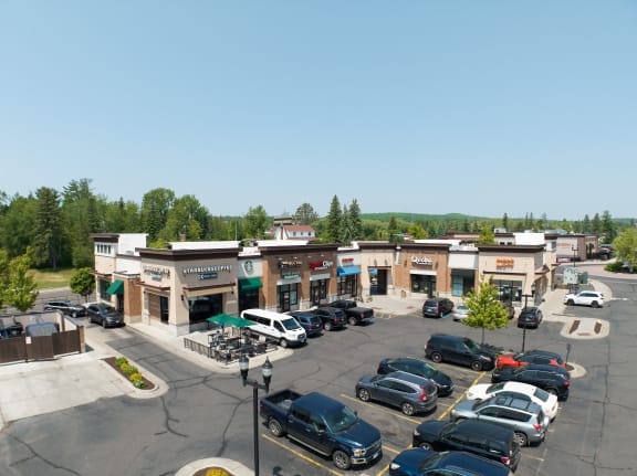 an aerial view of a shopping center with a parking lot full of cars  at Vue at Bluestone, Duluth, Minnesota