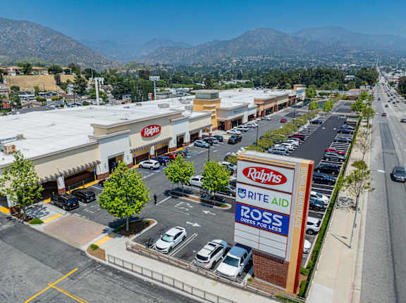 A parking lot is surrounded by buildings and roads.