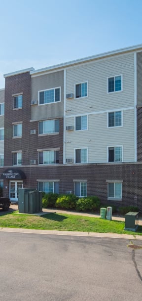 an apartment building with cars parked in front of it