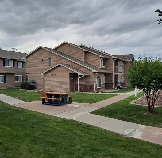 a delivery truck parked in front of a row of houses