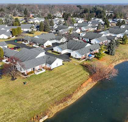 a neighborhood of houses next to a body of water