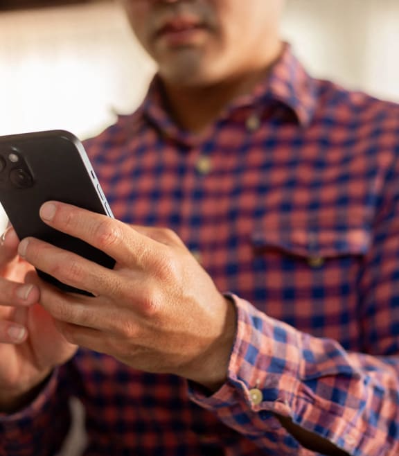 a man holding a cell phone in his hands