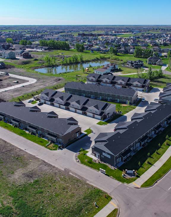 A large building complex with a parking lot in front of it.