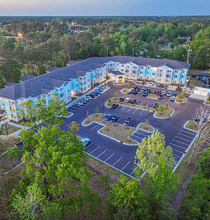A large building with a parking lot in front of it.