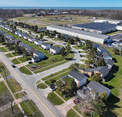 an aerial view of a neighborhood of houses and a highway