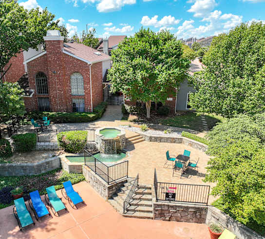 an aerial view of a backyard with a patio and a pool at Foxborough Apartments, Irving, TX