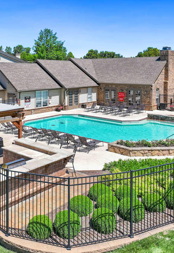 a backyard with a pool and a house with a patio