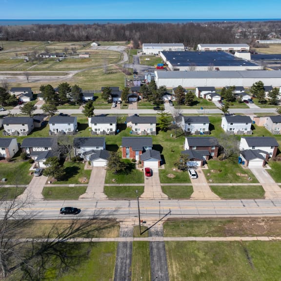 an aerial view of a neighborhood of houses with cars parked