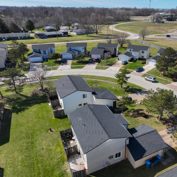 an aerial view of a neighborhood of houses with cars parked