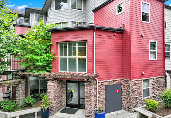 A red building with a black door and windows.