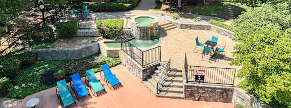 an aerial view of a backyard with a patio and a pool at Foxborough Apartments, Irving, TX