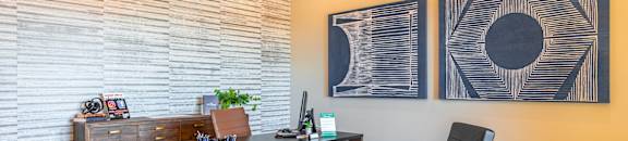 A room with a wooden desk and two chairs at Reserve of Bossier City Apartment Homes in LA 71111