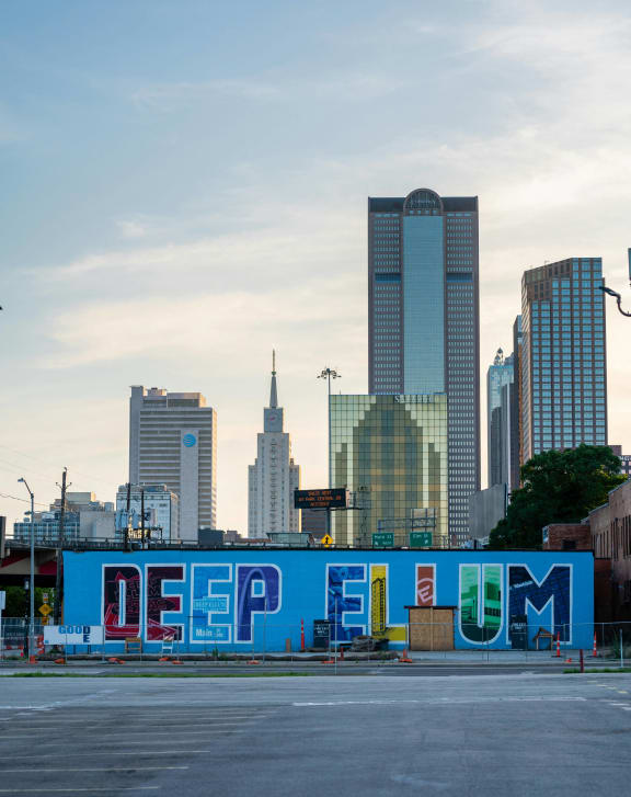 the city of downtown with graffiti on a wall