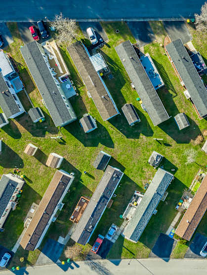 A bird's eye view of a residential area with houses and cars.