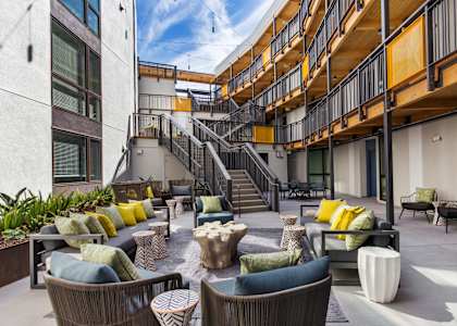 A patio with a staircase and furniture.