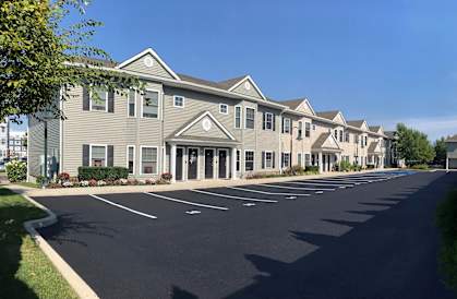 an empty parking lot in front of an apartment building
