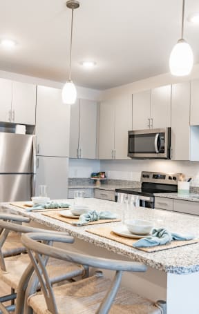 a kitchen with white cabinets and a table with chairs