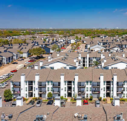 an aerial view of an apartment complex with rows of houses