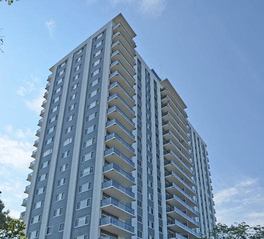a tall building with a car parked in front of it
