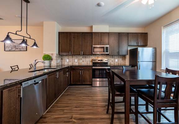 a kitchen with a island and a table with chairs