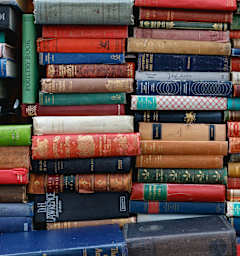 A stack of various old books.