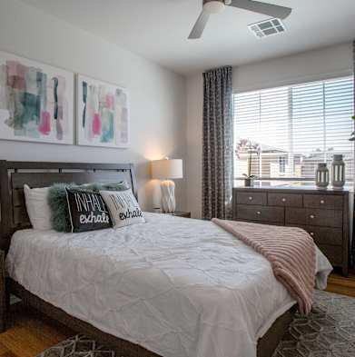 a bedroom with a bed and a large window