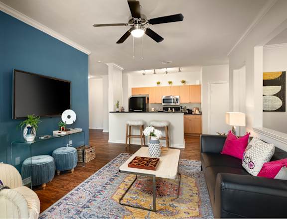A living room with a blue wall and a television.