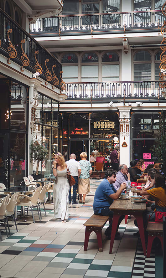 a city street with tall buildings and people walking