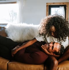 a man and woman laying on a couch