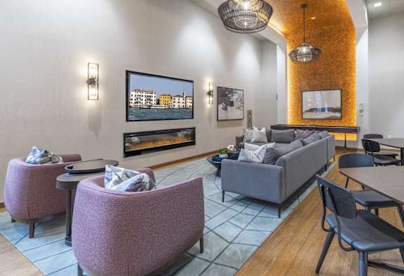 a living room with couches tables and chairs and a fireplace