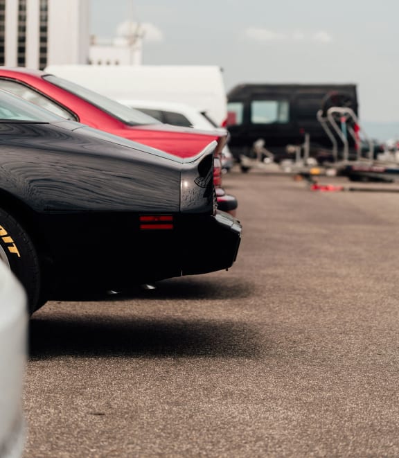a row of cars parked in a parking lot