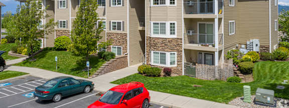 an apartment building with cars parked in front of it