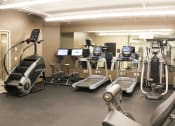 Thumbnail 6 of 8 - a gym full of exercise equipment in a building