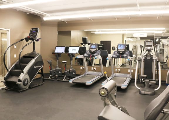 a gym full of exercise equipment in a building