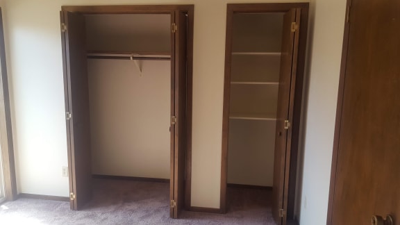 Image of a small closet with shelves and a larger closet with a rack for cloths