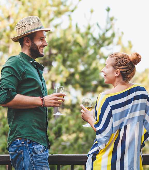 a man and a woman holding glasses of wine