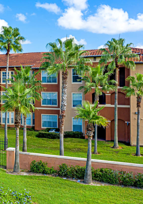 a large building with palm trees in front of it