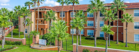 a large building with palm trees in front of it