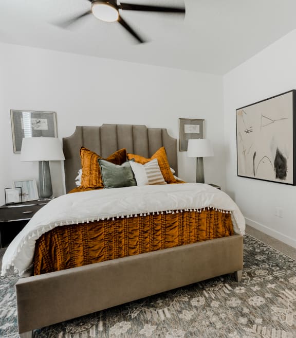 a bedroom with a large bed and a ceiling fan