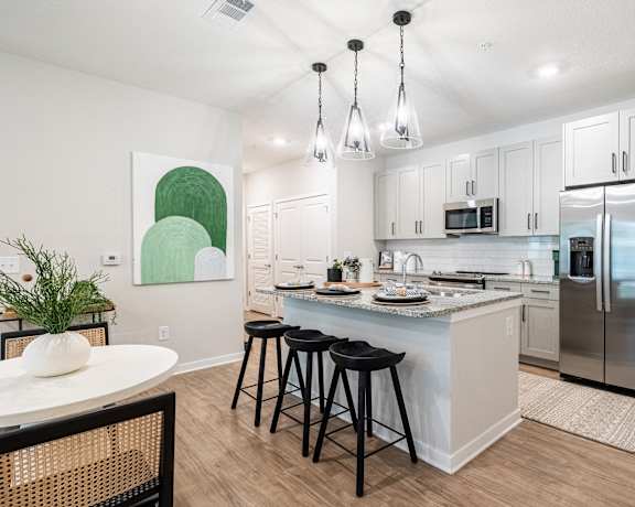 Open kitchen with three stools at Waterleaf at Salt Creek apartments in Savannah, GA